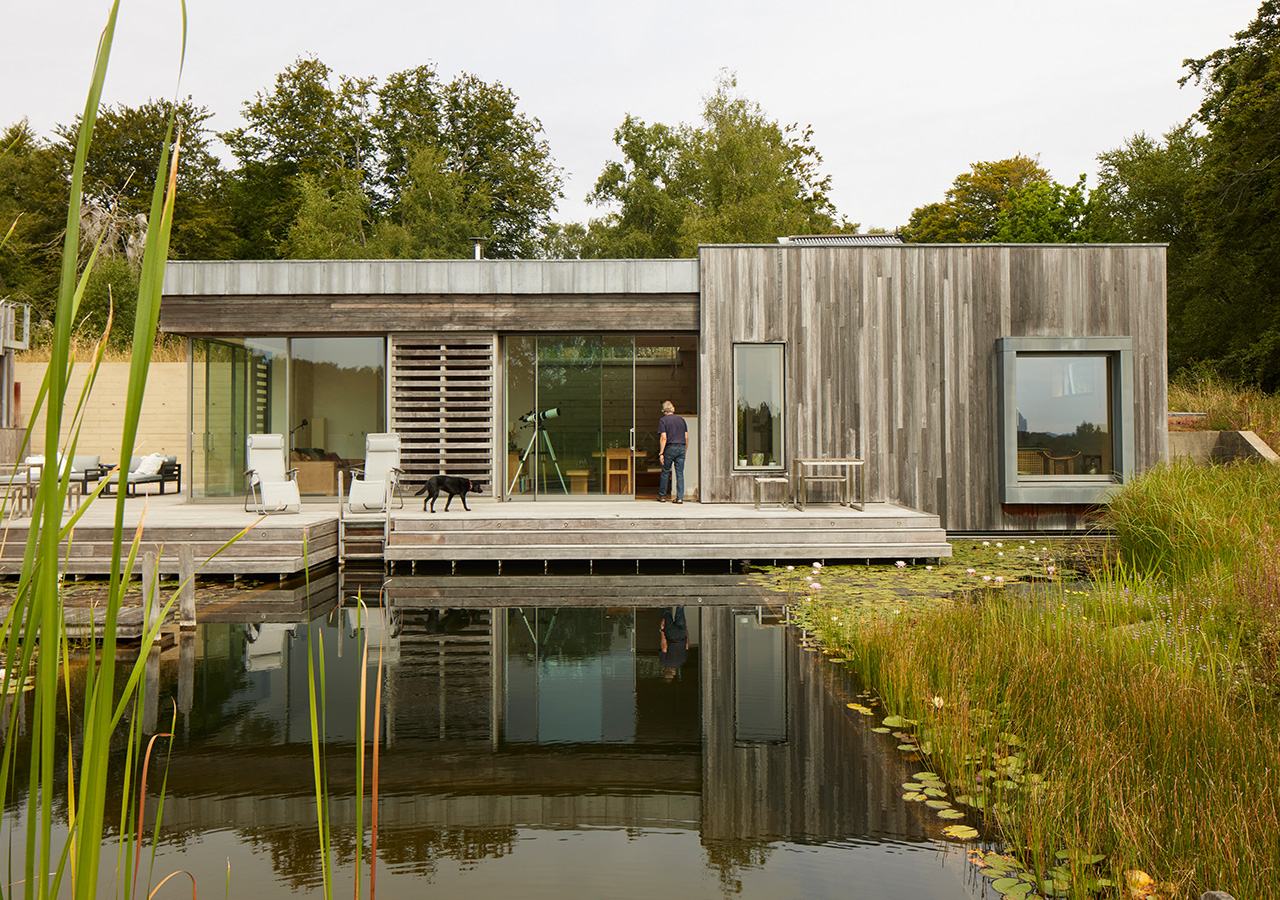 View across the natural pool to the crafted rural retreat and its inhabitants