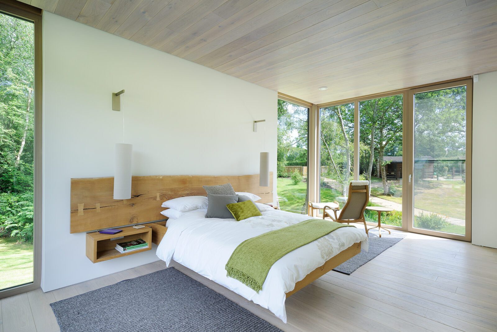 Floating bed with corner window connecting into the landscape