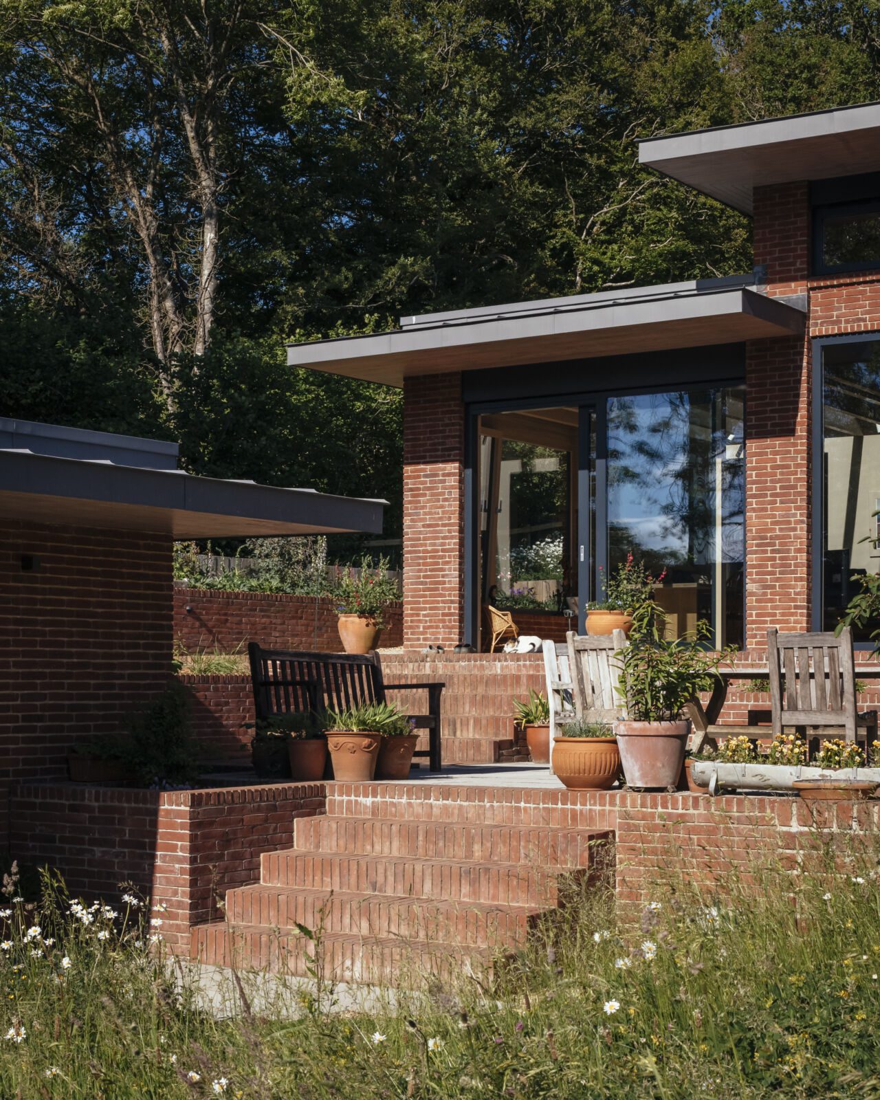 A set of terraces forms outdoor spaces at the Gardener's Cottage